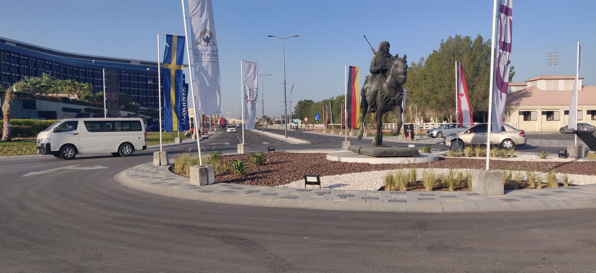 Completed roundabout with equestrian statue, landscaping and new roads at Al Forsan